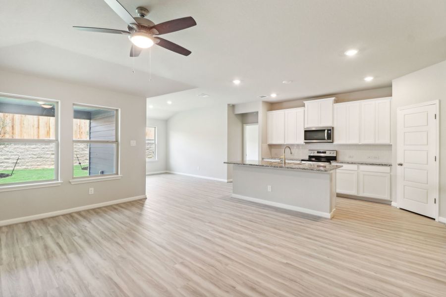 Dining room and kitchen in the Callaghan floorplan at a Meritage Homes community.