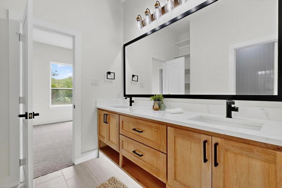 Full bathroom featuring light tile patterned flooring and double vanity Full bathroom featuring light tile patterned flooring and double vanity