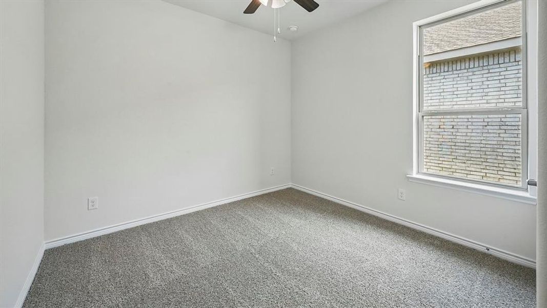 Unfurnished room featuring carpet flooring and ceiling fan