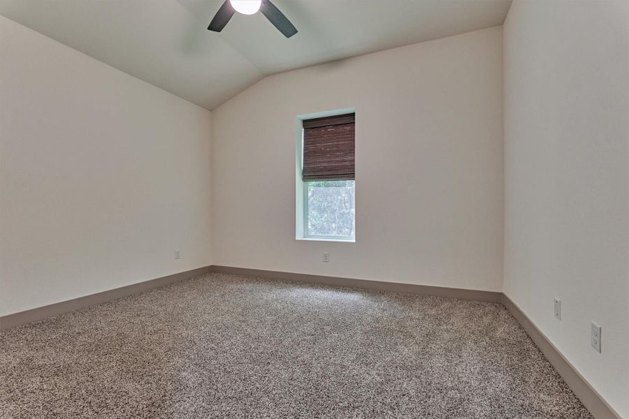 One of the two secondary bedrooms situated on opposite end of the home from the primary suite