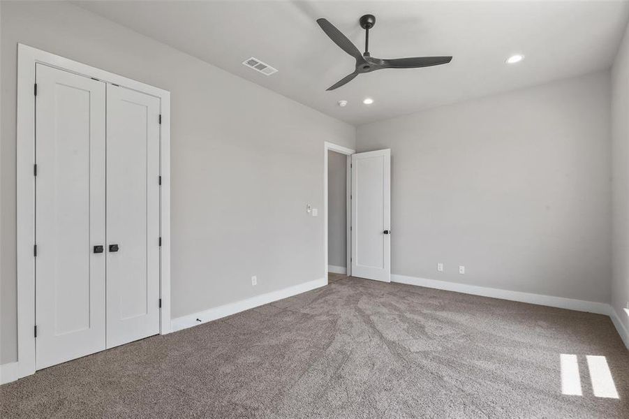 Unfurnished bedroom featuring carpet and ceiling fan