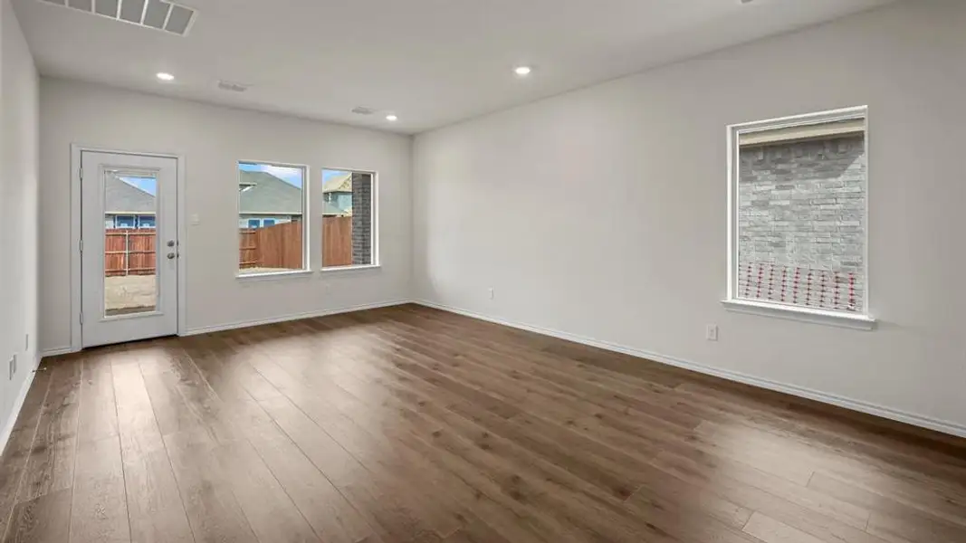 The property features light-colored walls, recessed lighting, and wood-style flooring