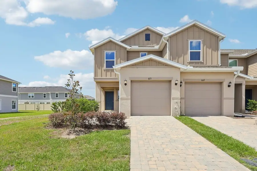 Front exterior of a new home in Reserve at Forest Lake Townhomes, Lake Wales, FL, highlighting curb appeal (Image 1). Front exterior of a new home in Reserve at Forest Lake Townhomes, Lake Wales, FL, highlighting curb appeal (Image 1).