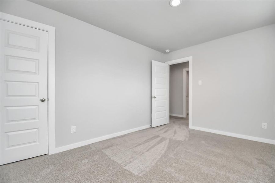 Generously sized secondary bedrooms featuring spacious closets, soft and inviting carpeting underfoot, large windows allowing plenty of natural light, and the added touch of privacy blinds for your personal retreat.