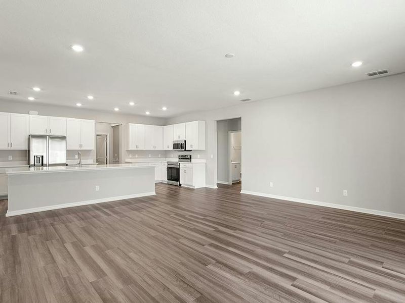 This home features a sunny, open living area with LVP flooring.