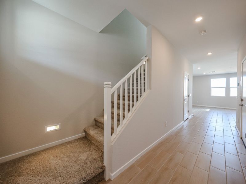 A white staircase in a house. A white staircase in a house.