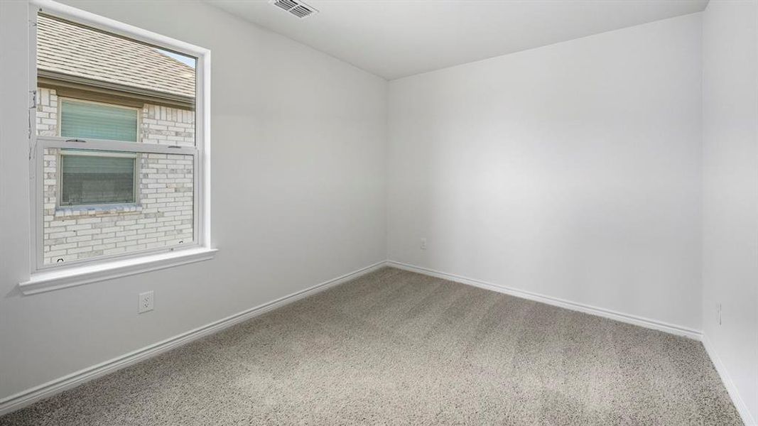 Empty room featuring carpet flooring and baseboards