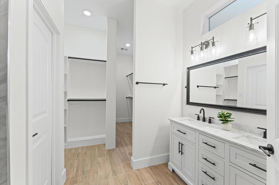 Spa-like primary bath featuring dual sinks, a luxurious walk-in shower with designer tile, and modern finishes that create a serene retreat for relaxation. Spa-like primary bath featuring dual sinks, a luxurious walk-in shower with designer tile, and modern finishes that create a serene retreat for relaxation.