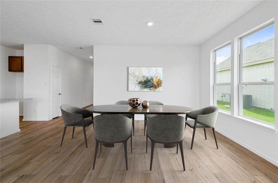 Start your day off right with a cup of coffee sitting with your family in the lovely breakfast/dining area! Featuring custom paint, vinyl plank flooring, recessed lighting and large windows with privacy blinds.