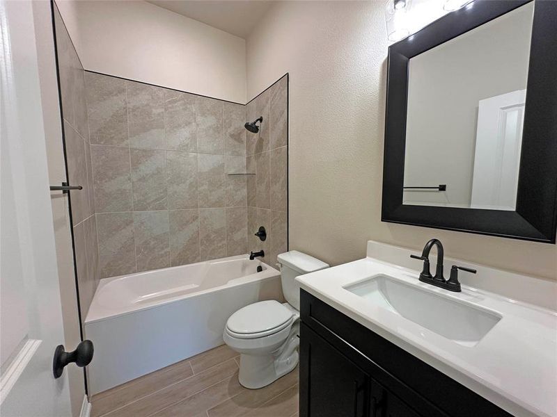 Full bathroom with vanity, bathtub / shower combination, and wood finish floors