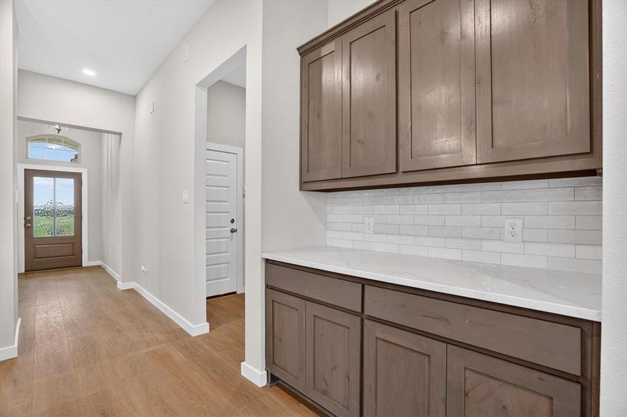 Entryway featuring wood-finish flooring, recessed lighting, and a front door with an arched transom window
