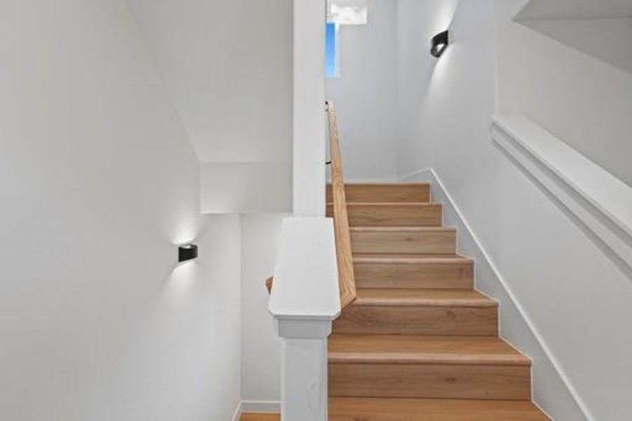 Stairs featuring hardwood / wood-style flooring