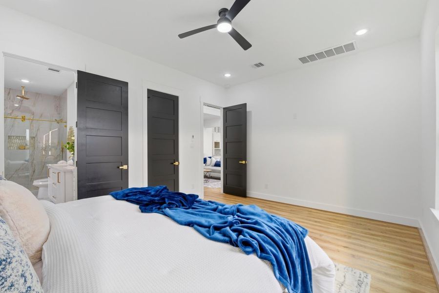 Plenty of room in the primary suite and notice the high ceilings and sleek black doors with gold hardware adding that amazing attention to detail.