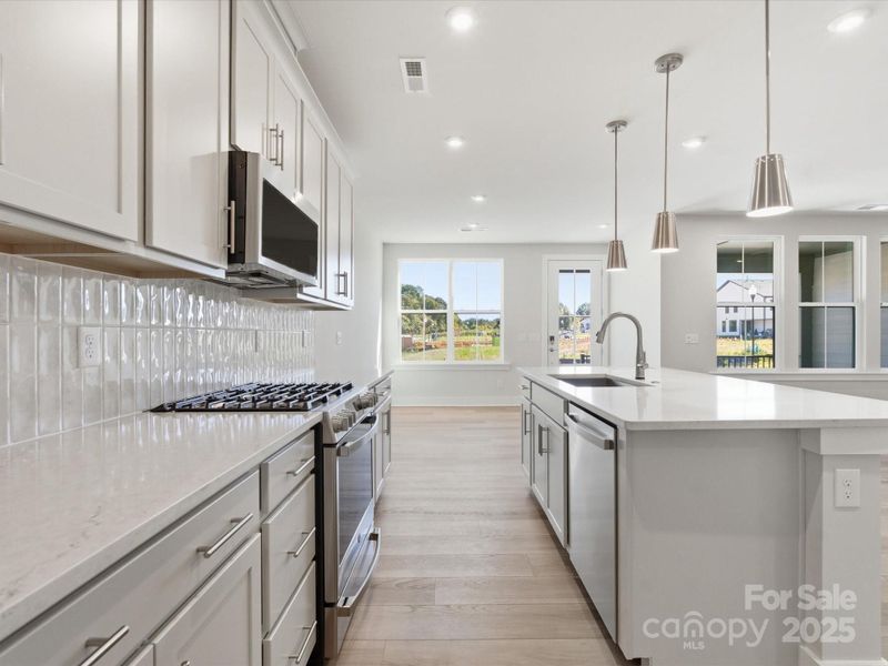 Designer Stainless Pendant Lighting Brightens the Space.