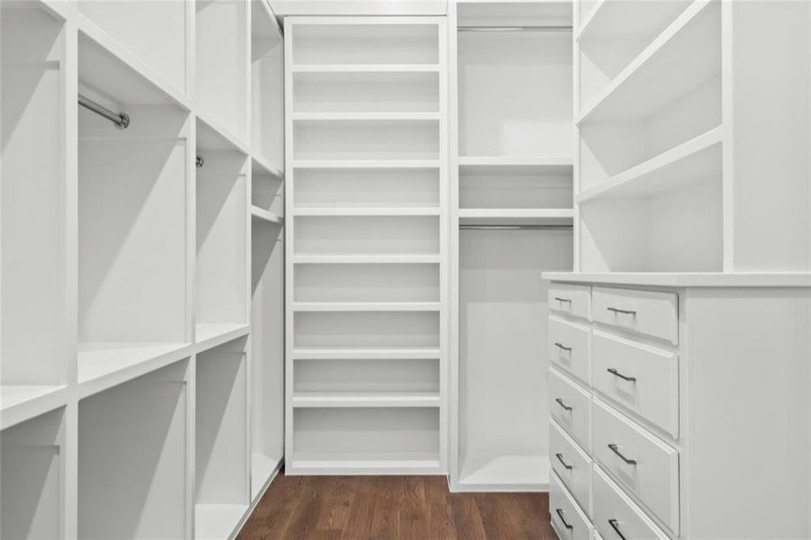 Walk in closet with dark wood-style floors Walk in closet with dark wood-style floors