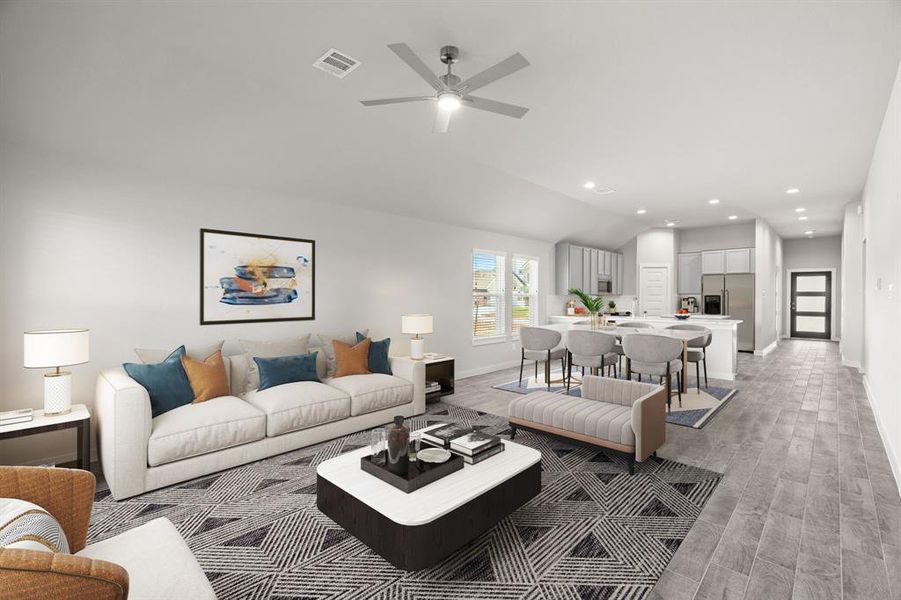 Gather your loved ones and guests in the welcoming living room! Enjoy the spaciousness created by lofty high ceilings, complemented by the glow of recessed lighting and the gentle breeze from a stylish ceiling fan.  Sample photo of completed plan. As-built color and selections may vary.