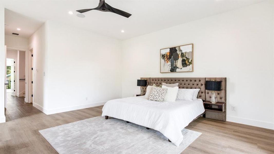 Bedroom with ceiling fan and light wood-type flooring