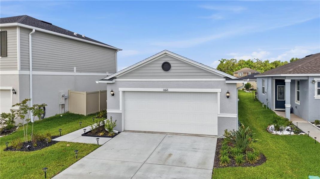 Front exterior of a new home in Magnolia Creek, Riverview, FL, highlighting curb appeal (Image 23). Front exterior of a new home in Magnolia Creek, Riverview, FL, highlighting curb appeal (Image 23).