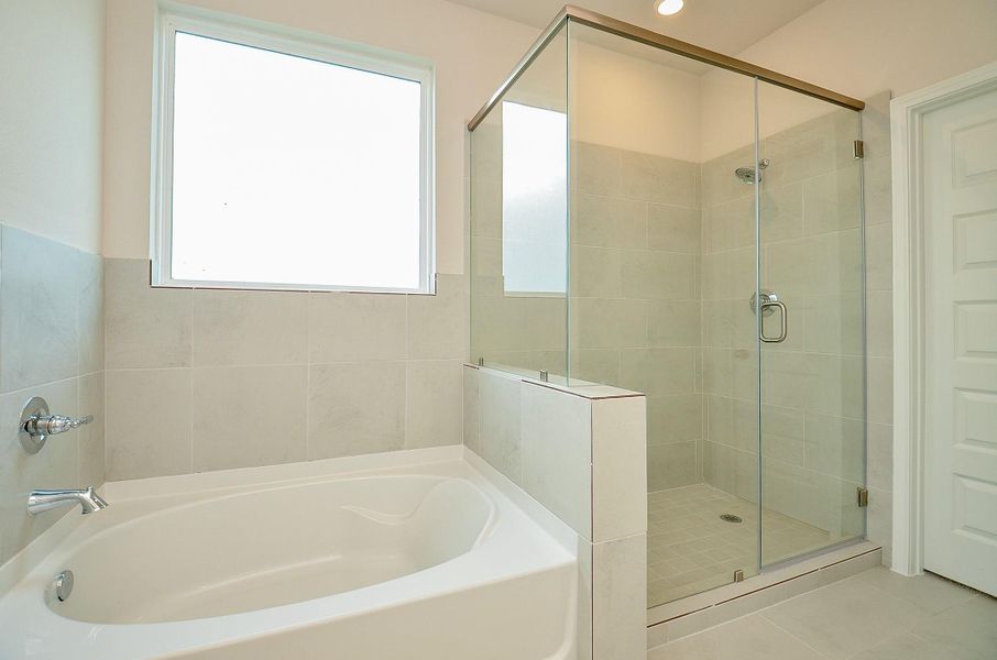 Notice the deep soaking tub and glass-door enclosed shower. Notice the deep soaking tub and glass-door enclosed shower.