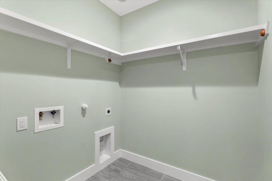 Laundry room with hookup for a gas dryer, electric dryer hookup, and hookup for a washing machine