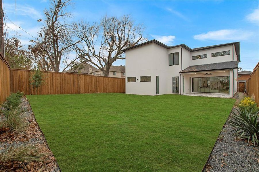 Back of house with stucco siding and ceiling fan Back of house with stucco siding and ceiling fan