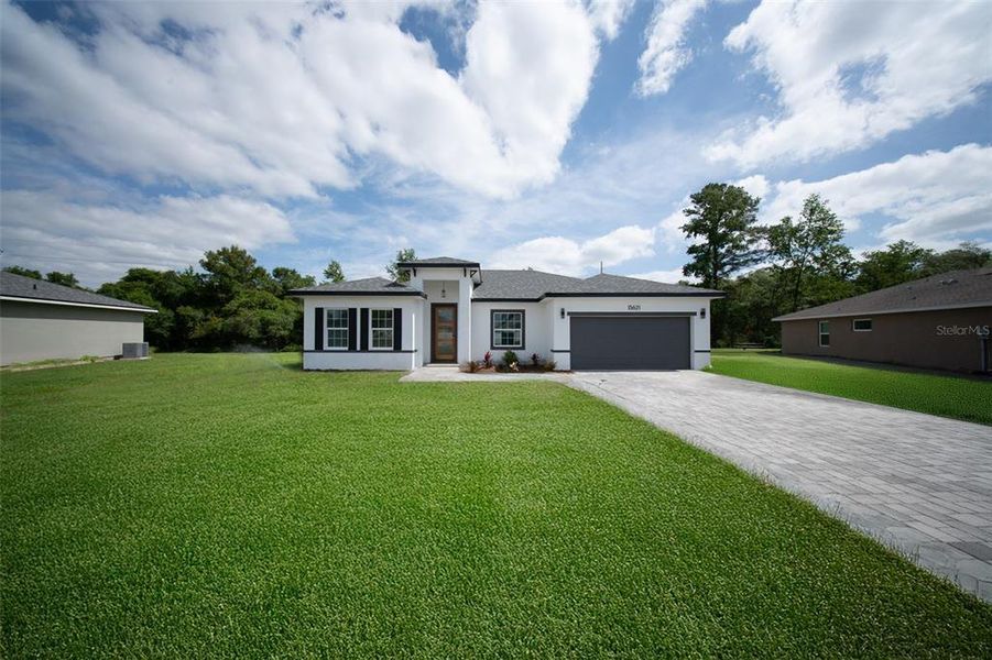 Front exterior of a new home in , Ocala, FL, highlighting curb appeal (Image 1).
