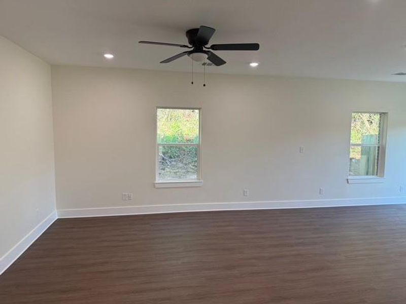 Living Room with natural light, ceiling fan and vinyl plank flooring Living Room with natural light, ceiling fan and vinyl plank flooring