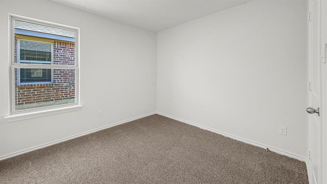 Interior room featuring a double-hung window with blinds, neutral carpet flooring, white walls, and white trim