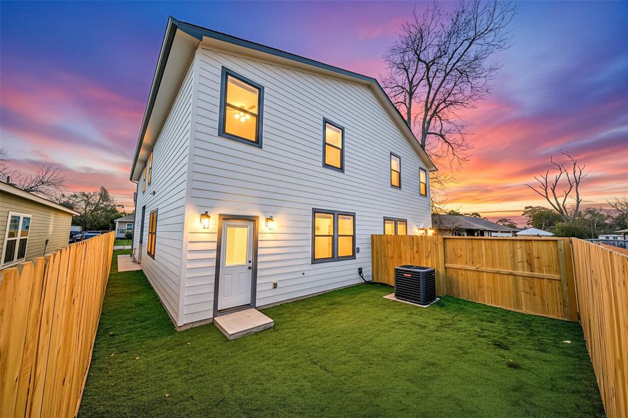 Private, fenced backyard with rear entry and exterior lighting, offering a peaceful outdoor space perfect for relaxing or entertaining. Private, fenced backyard with rear entry and exterior lighting, offering a peaceful outdoor space perfect for relaxing or entertaining.