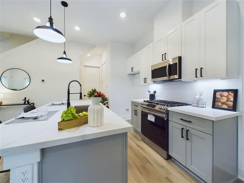 This attractive Kitchen is full of beautiful details. Quartz Countertops, Stainless Steel Sink, Stainless Steel Appliances, Recessed Lighting, Undercabinet Lighting, Elegant Cabinetry with Soft Close Drawers and Doors. Model home photos, finishes and floor plan MAY VARY!