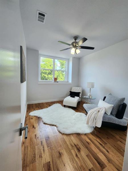 Bedroom with hardwood / wood-style flooring and ceiling fan