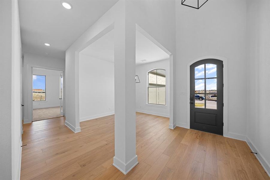 Entryway with healthy amount of natural light, light wood-type flooring, and recessed lighting