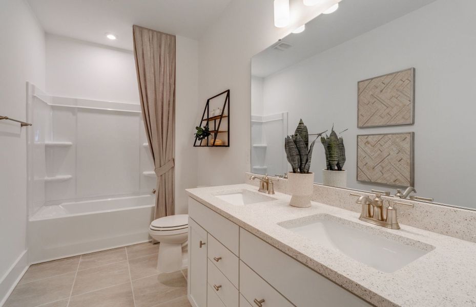 Secondary bathroom with a soaking tub equipped with shelves.