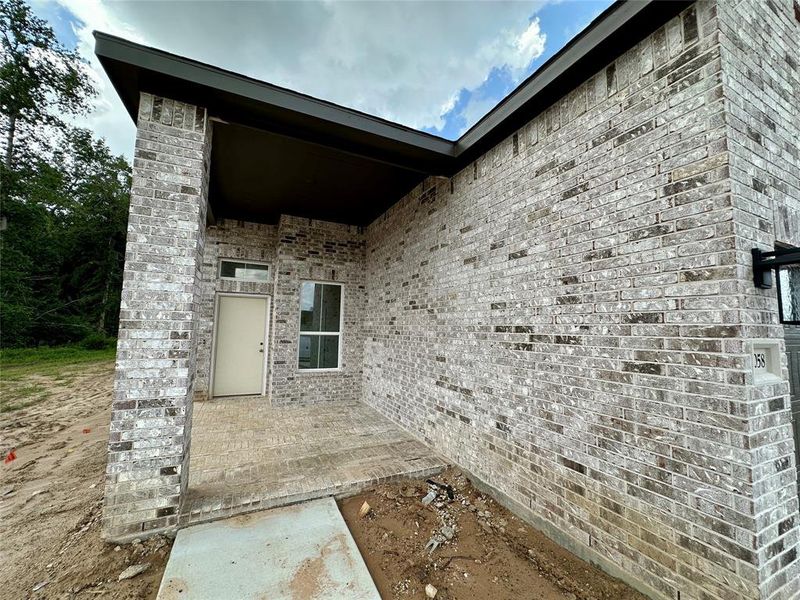 Front exterior of a new home in Evergreen, Conroe, TX, highlighting curb appeal (Image 9). Front exterior of a new home in Evergreen, Conroe, TX, highlighting curb appeal (Image 9).