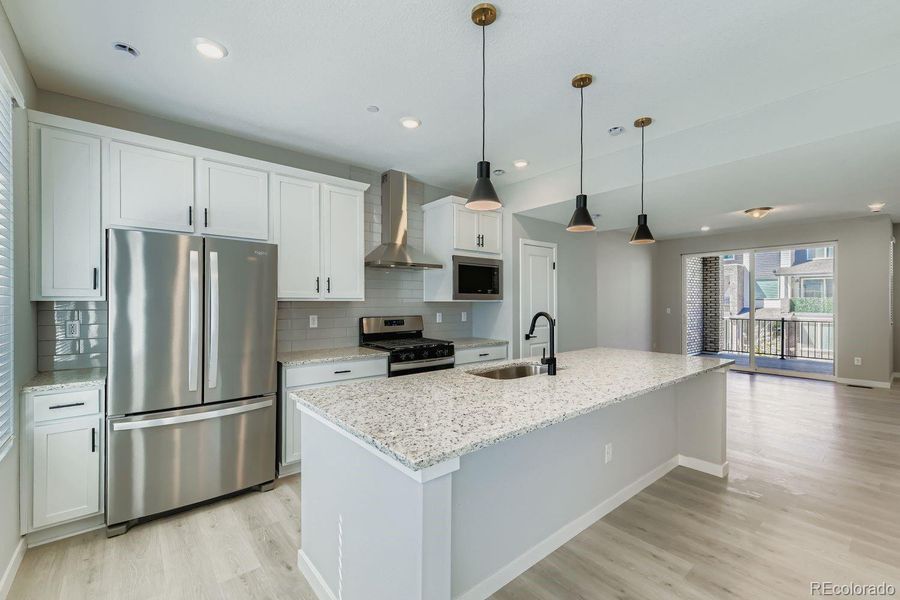 Upgraded Chef's Kitchen with included refrigerator. Fumehood vents outside