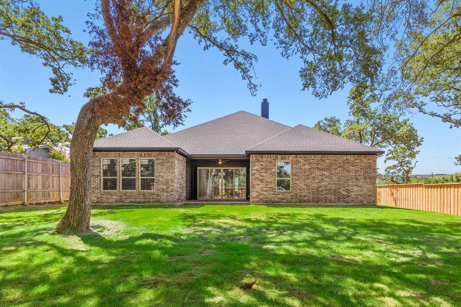 View of front facade with a back yard featuring large sliding door