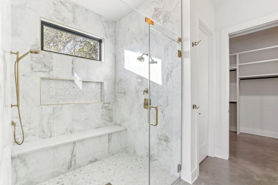 A spacious walk-in shower adds a spa-like touch to your daily routine