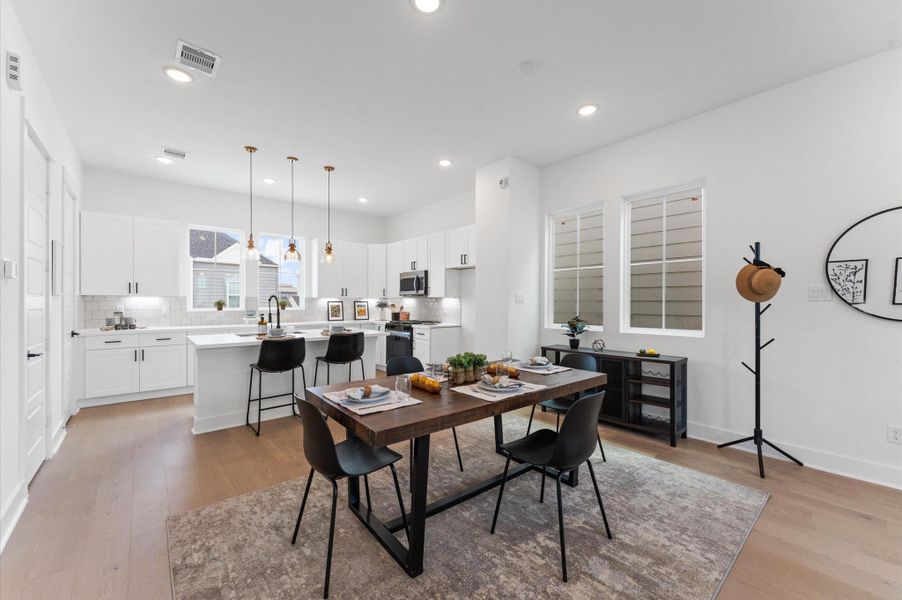 Designed for modern living, this open-concept space seamlessly unites the kitchen, dining, and living areas into one harmonious hub.
