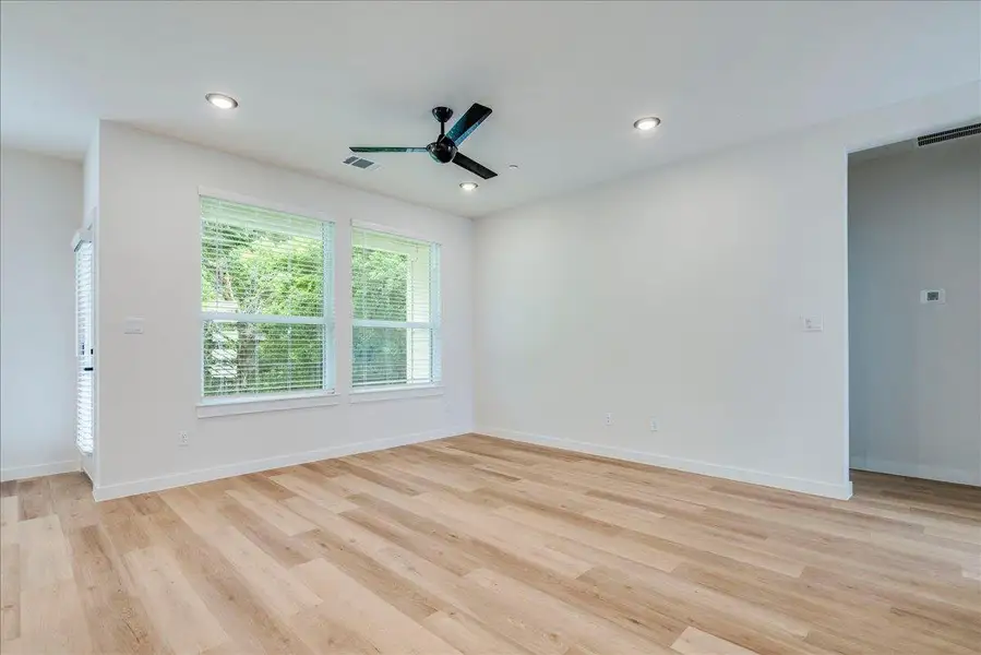 A well-lit interior space with natural wood flooring and recessed lighting.
