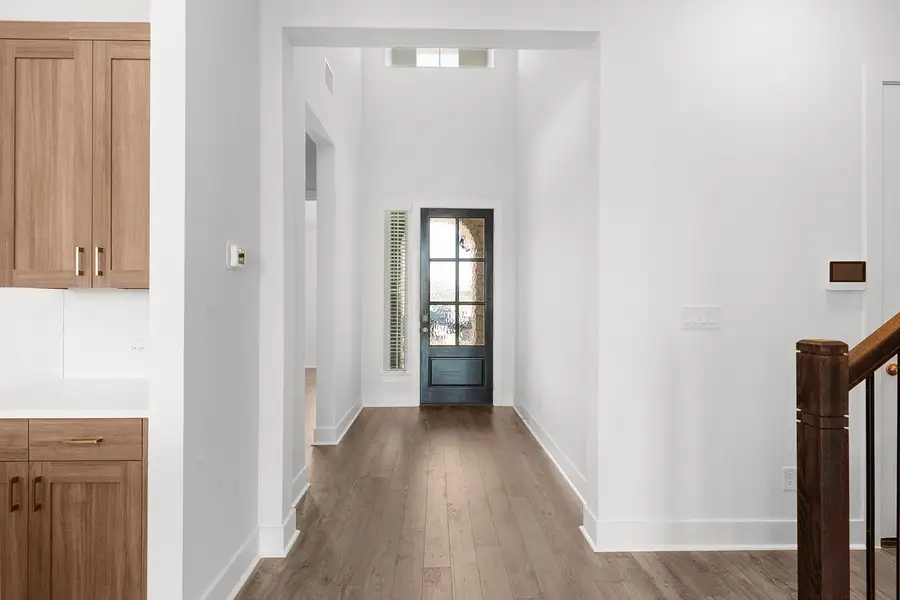 A well-lit entry hall with soaring ceilings welcomes you into this inviting residence.
