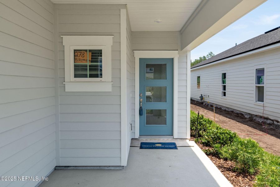 Front exterior of a new home in Beacon Lake, St. Augustine, FL, highlighting curb appeal (Image 23).