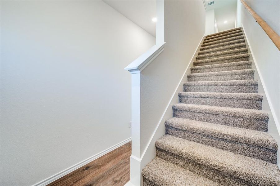 Staircase with hardwood / wood-style flooring