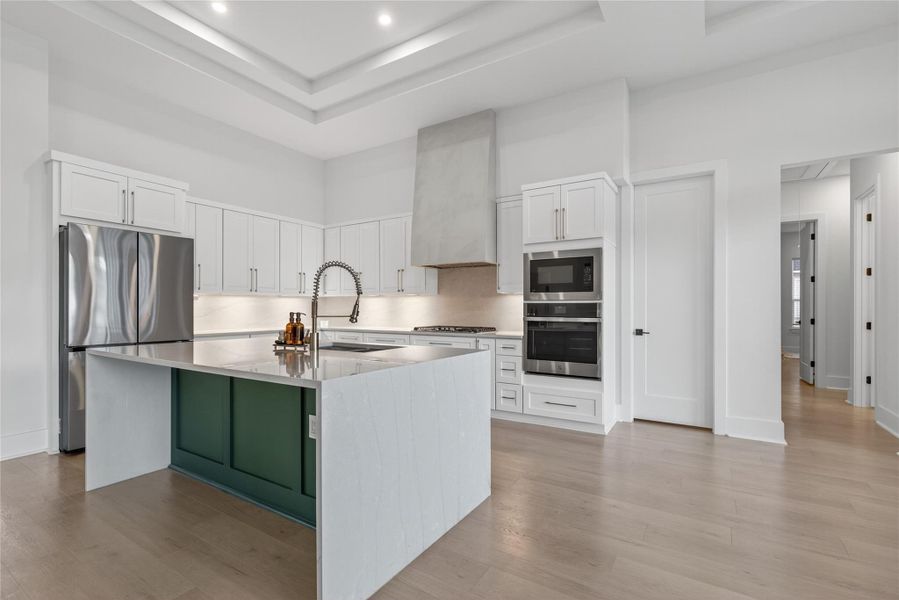 Beautiful kitchen combines modern finishes, abundant storage, and an expansive island overlooking the open living area. **Images are from a previously completed project. **