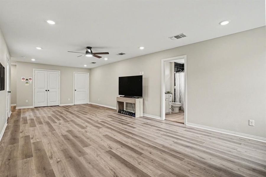2nd Floor Living, Pre Plumbed for separate kitchenette and guest quarters w a ceiling fan, light wood vinyl floors, and recessed lighting