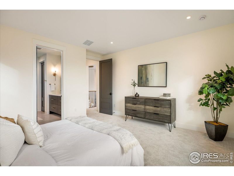 Upstairs Primary Bedroom sits just off the bridgeway above the entry - perfect seclusion without being far-removed from all of the home's activity