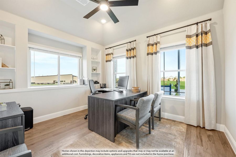 Home office with dark wood desk, two chairs, hardwood floors, and large windows with curtains Home office with dark wood desk, two chairs, hardwood floors, and large windows with curtains