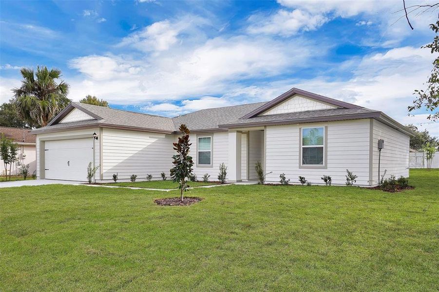 Front exterior of a new home in Palm Coast, Palm Coast, FL, highlighting curb appeal (Image 2). Front exterior of a new home in Palm Coast, Palm Coast, FL, highlighting curb appeal (Image 2).