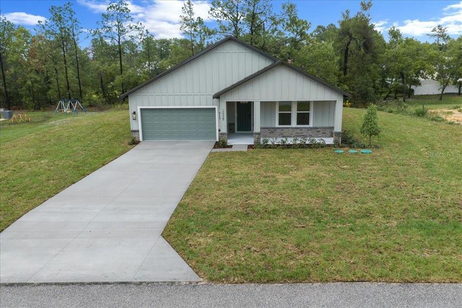 Front exterior of a new home in , Weeki Wachee, FL, highlighting curb appeal (Image 32). Front exterior of a new home in , Weeki Wachee, FL, highlighting curb appeal (Image 32).