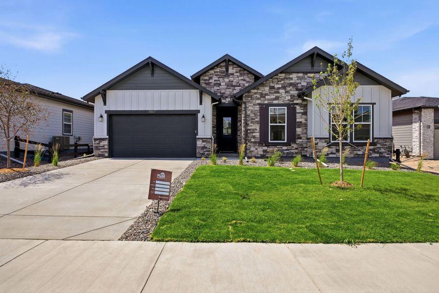 Front exterior of a new home in Hilltop at Inspiration, Aurora, CO, highlighting curb appeal (Image 2).