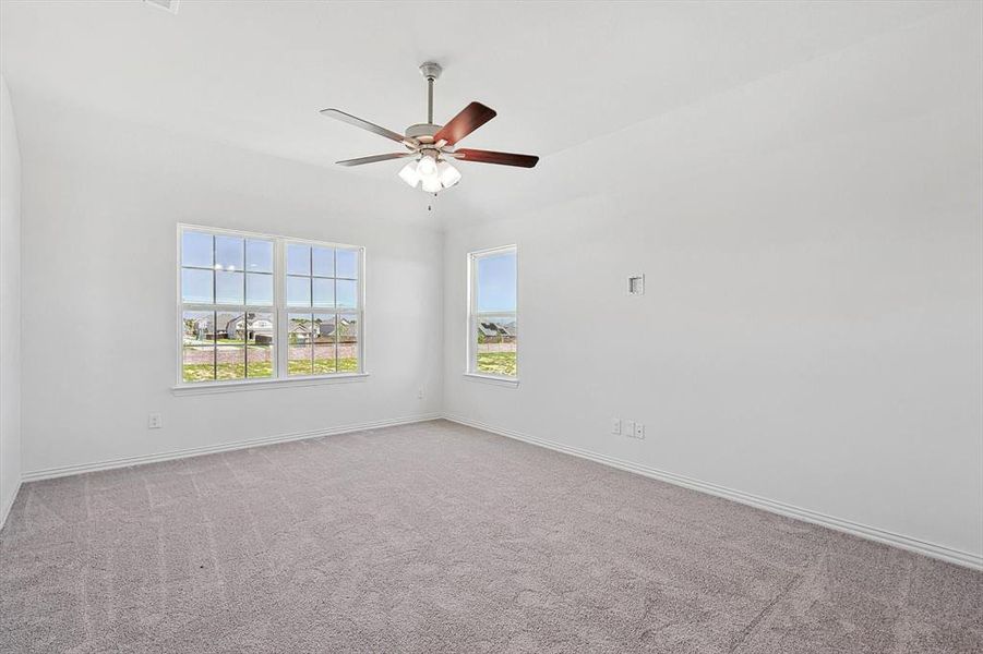 Unfurnished room with light colored carpet and ceiling fan